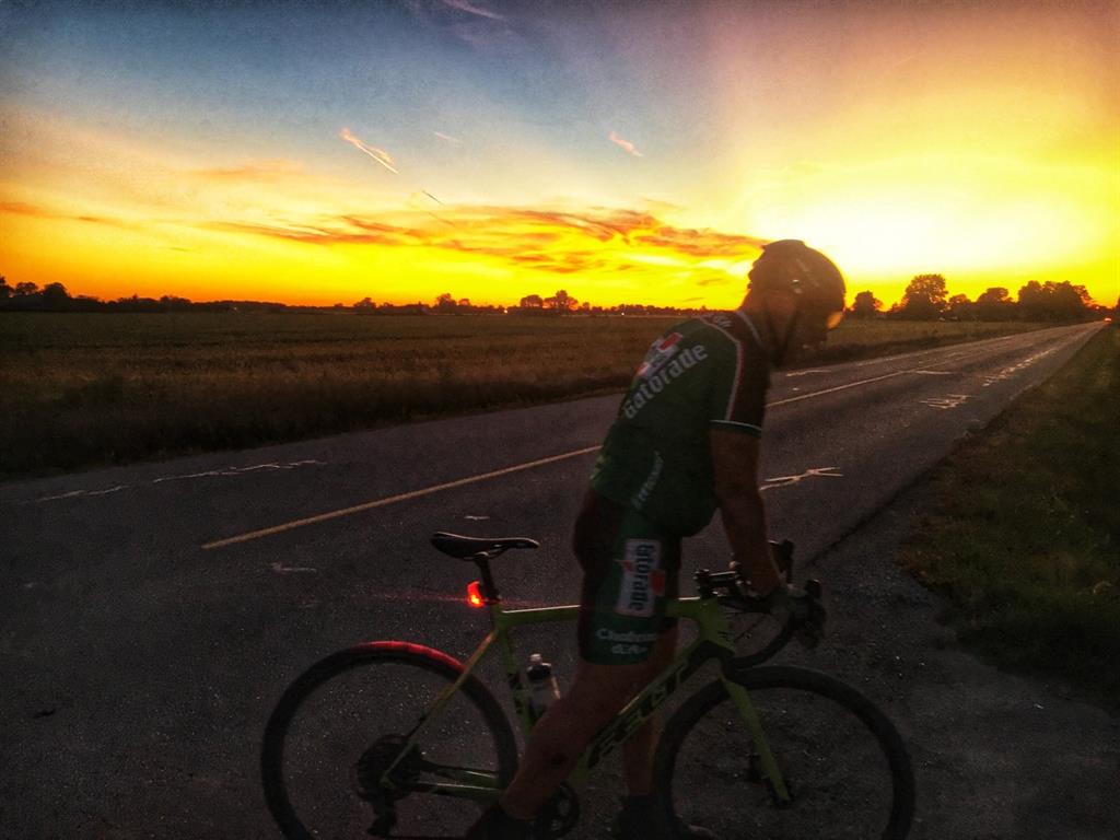 Rick Meloche on his bike in front of the sunset